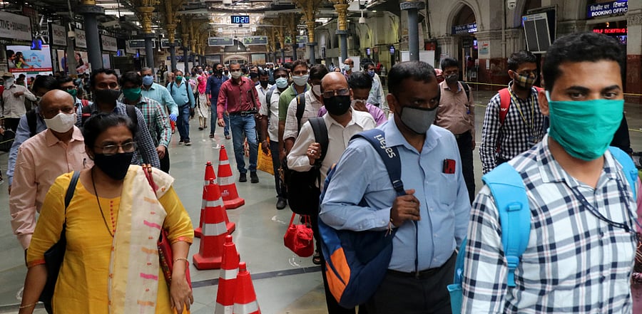 People wearing protective face masks leave the Chhatrapati Shivaji Terminus railway station. Credit: Reuters Photo