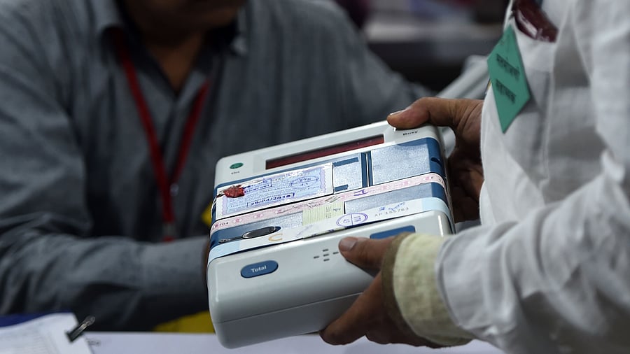 An Indian official inspects an Electronic Voting Machine (EVM). Credits: AFP Photo