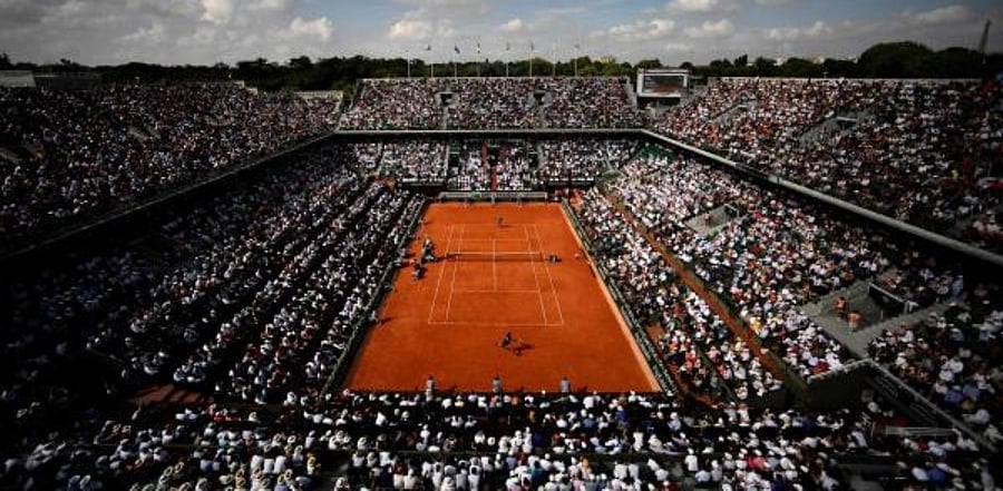 In this file photo taken on June 8, 2018 spectators watch Spain's Rafael Nadal (TOP) as he plays Argentina's Juan Martin del Potro during their men's singles semi-final match on day thirteen of The Roland Garros 2018 French Open tennis tournament in Paris. Credit: AFP Photo