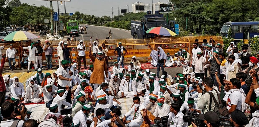 Farmers shout slogans as they block the Delhi-Uttar Pradesh border during a protest against farm bills passed by India's parliament, in New Delhi, India. Credit: Reuters