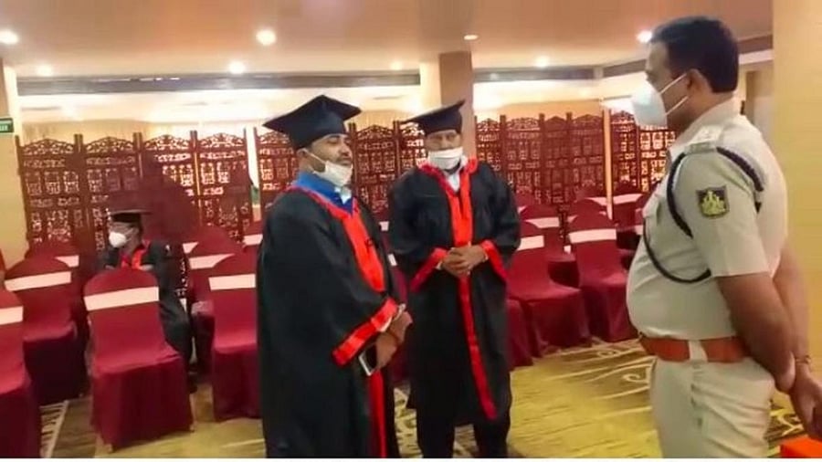 Deputy Commissioner of Police (DCP) A N Prakash Gowda inquires candidates of honorary degrees at a private Hotel in Mysuru on Saturday.
