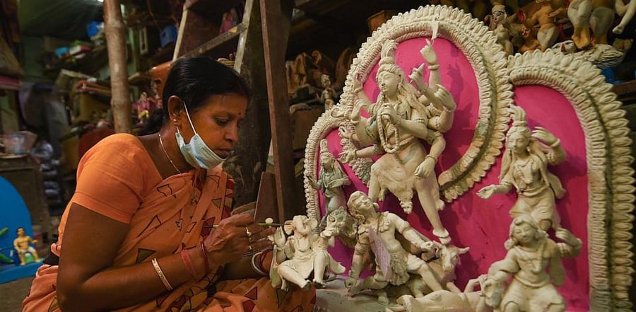 An artisan makes an idol of Goddess Durga for the upcoming Durga Puja festival, at Kumartuli in Kolkata, Sunday, Sept. 20, 2020. Credit: PTI Photo