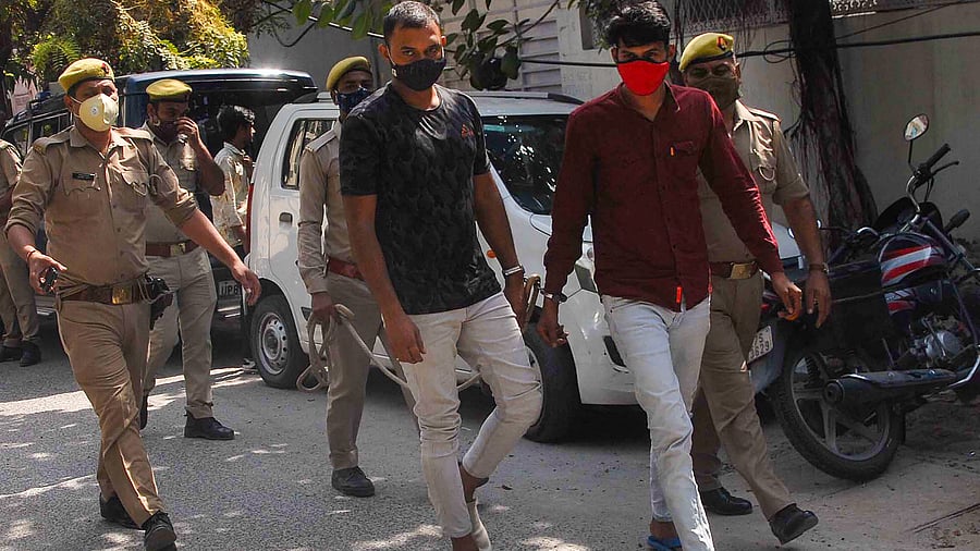 Two of the three accused in a honey trap of a Defense Research and Development Organization (DRDO) scientist being taken to police station, in Noida. Credits: PTI Photo