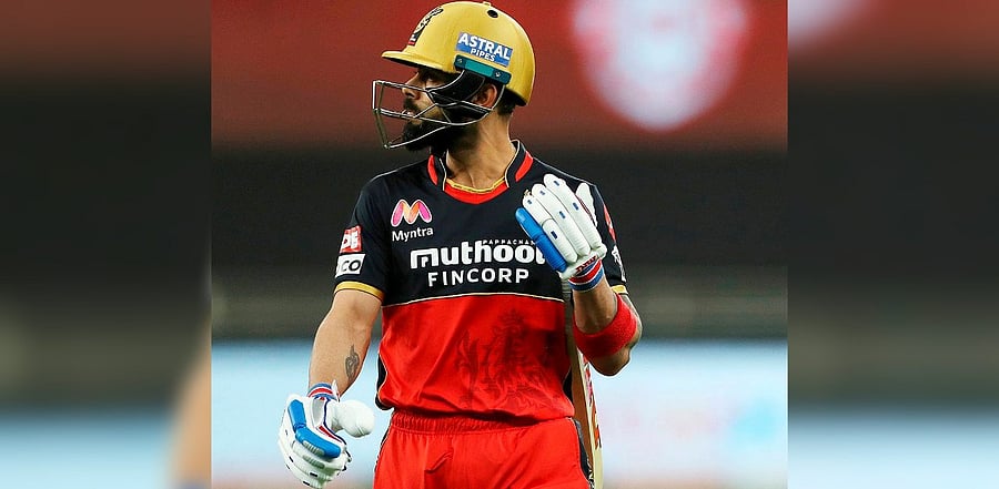 Royal Challengers Bangalore (RCB) skipper Virat Kohli walks towards the pavillion after being dismissed during IPL 2020 cricket match against Kings XI Punjab, at Dubai International Cricket Stadium in Abu Dhabi. Credit: PTI