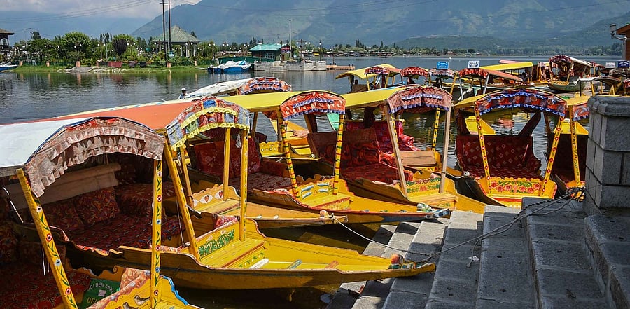 Shikaras lay abandoned at a ghat in Srinagar. Credit: PTI Photo