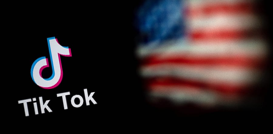 Logo of the social network application TikTok and a US flag. Credit: AFP Photo