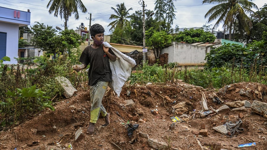 Rahul, 11, collects plastic to sell to a recycler in Tumakuru. Atul Loke for The New York Times