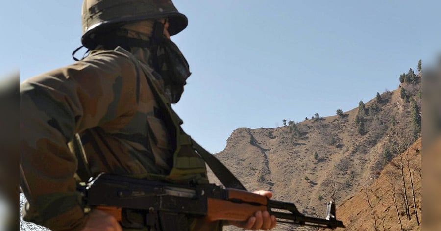 An army jawan keeps vigil in Poonch district of Jammu and Kashmir on Sunday after ceasefire violations by Pakistan along the LoC. Credit: PTI Photo