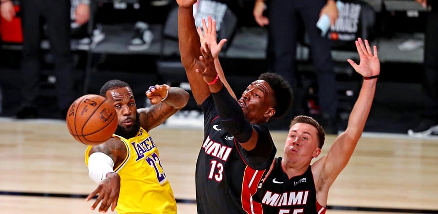 Los Angeles Lakers forward LeBron James (23) passes the ball against Miami Heat forward Bam Adebayo (13) during the third quarter in game one of the 2020 NBA Finals. Credit: Reuters