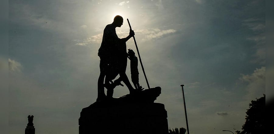 A worker cleans a statue of Indian independence icon Mahatma Gandhi at Marina Beach ahead of Gandhi's 151st birth anniversary celebrations in Chennai on October 1, 2020. Credit: AFP Photo