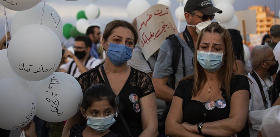 Relatives of the blast victims attend a ceremony to release scores of white balloons bearing the names of victims. Credit: AP Photo