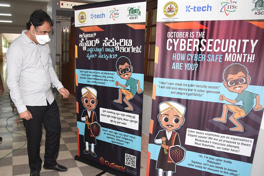Deputy Chief Minister Dr C N Ashwath Narayan with the mascots unveiled during a programme to mark Cybersecurity Month, in Bengaluru on Monday. DH Photo/Dinesh S K
