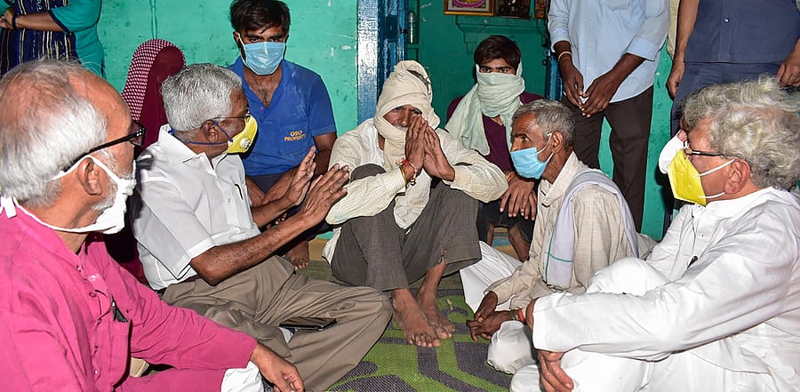  CPI(M) leaders Sitaram Yechury, D Raja, and others meet the family members of a 19-year-old Dalit woman who died after being allegedly gang-raped, at Bulgadi village in Hathras. Credit: PTI Photo