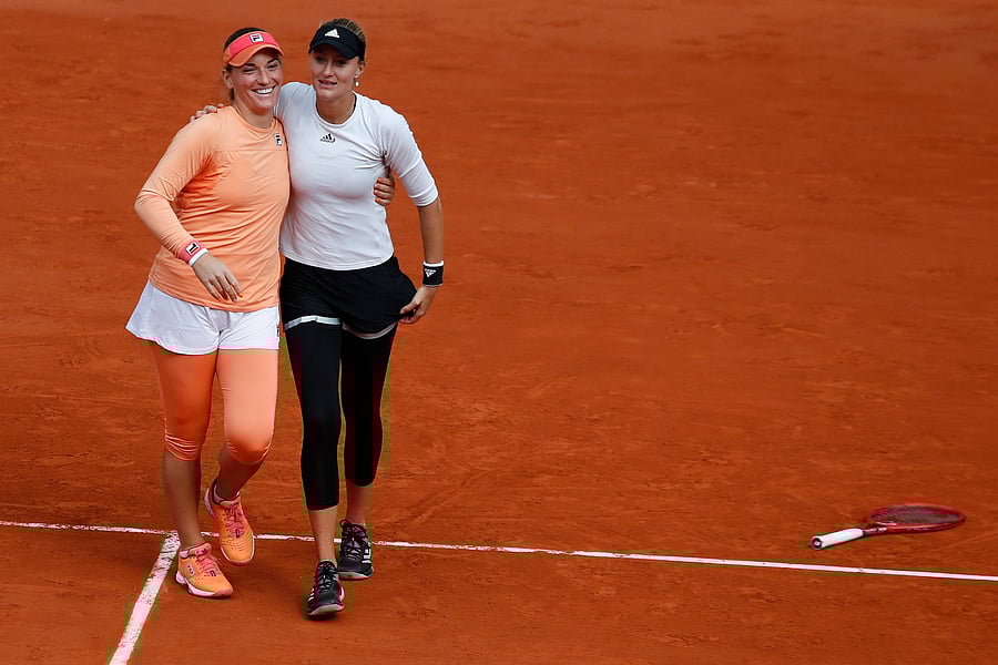 Hungary's Timea Babos, left, hugs France's Kristina Mladenovic after winning the women's doubles final match of the French Open tennis tournament against Chile's Alexa Guarachi and Desirae Krawczyk of the U.S. at the Roland Garros stadium in Paris, France, Sunday, Oct. 11, 2020. Credit: AP/PTI