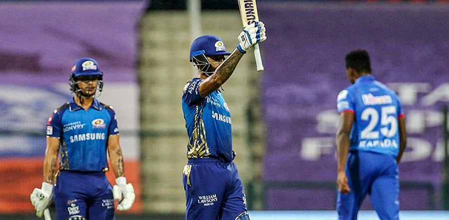 Mumbai Indians (MI) batsman Surya Kumar Yadav raises his bat after scoring a half-century during Indian Premier League (IPL) cricket match against Delhi Capitals (DC), at Sheikh Zayed Stadium in Abu Dhabi, Sunday, Oct. 11, 2020. (PTI)