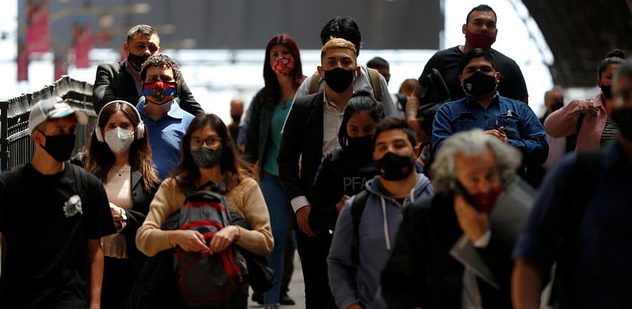 Commuters walk along a platform at Retiro train station, during the spread of the coronavirus disease, in Buenos Aires, Argentina. Credit: Reuters