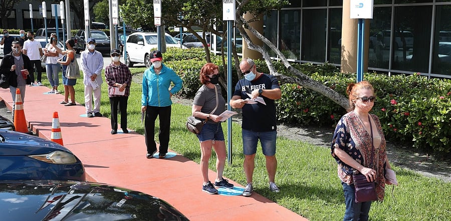 Voters wait in line to drop off their Vote-by Mail ballots at the Miami-Dade Election Department headquarters. Credit: AFP Photo