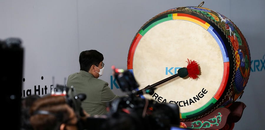 Bang Si-hyuk, founder of Big Hit Entertainment Co., hits the drum during the company's initial public offering ceremony at the Korea Exchange in Seoul, South Korea. Credit: Reuters