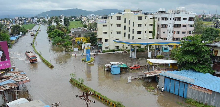 A bus moves through waterlogged Karad-Vita highway following heavy rain, in Karad. credit: PTI Photo