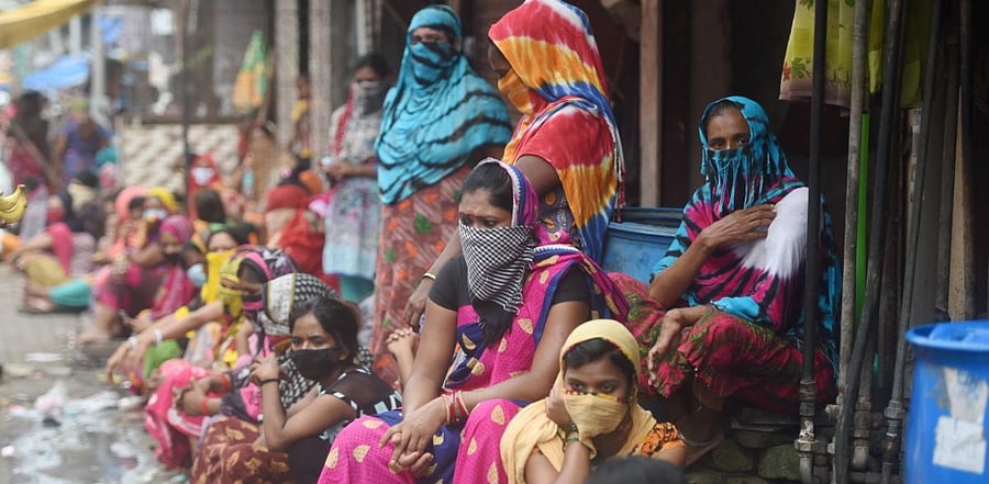Sex workers wait to collect free groceries, distributed by Manava Vatsalya Foundation, an NGO, at the red-light area of Kamathipura in Mumbai. Credit: PTI Photo