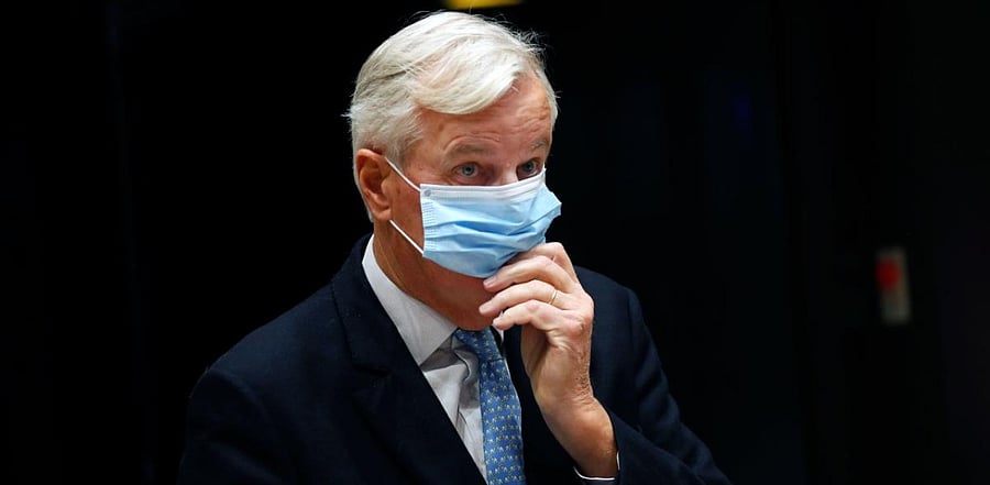 European Union chief Brexit negotiator Michel Barnier pulls down his face mask as he leaves a media conference at on the first of a two-day European Union (EU) summit at the European Council Building in Brussels. Credit: AFP