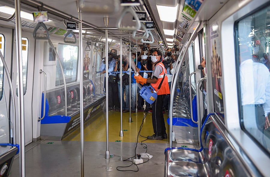 An employee sanitises a coach after Mumbai Metro One Private Limited (MMOPL) allowed resumption. Credits: PTI Photo