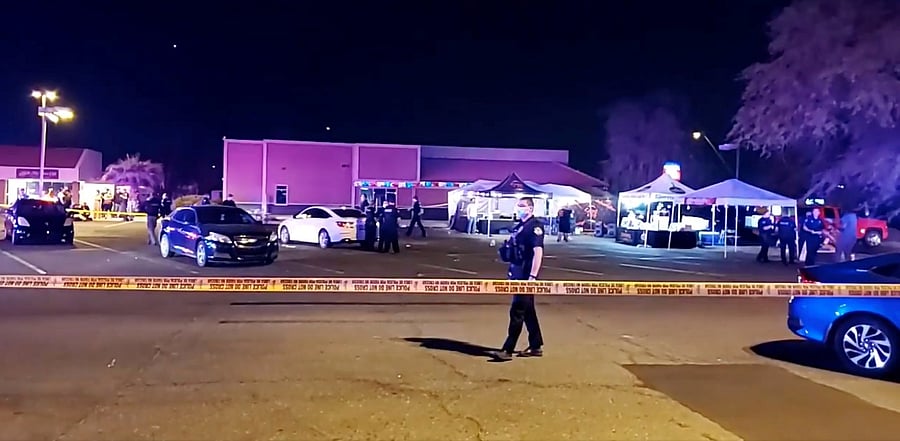 A police officer stands in a parking lot following a shooting in Mesa. Credit: Reuters Photo