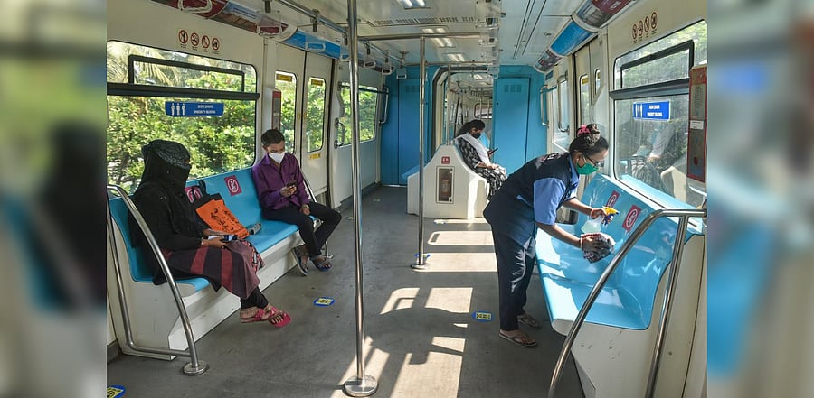 A worker sanitizes seats in a monorail as the Mumbai Monorail service between Chembur and Lower Parel area reopened after nearly 7 months, following the coronavirus pandemic, in Mumbai, Sunday, Oct. 18, 2020.  Credit: PTI Photo
