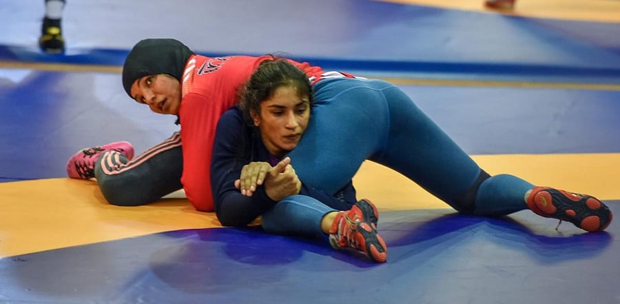 Indian wrestler Sakshi Malik (red) with Vinesh Phogat during a training session. Credit: PTI