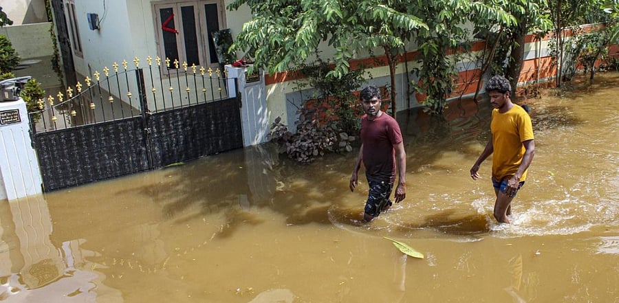 People were seen walking in knee-deep water in some areas. Credit: PTI