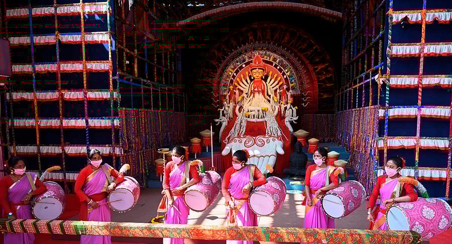 Traditional drummers play perform near an idol of the ten-armed Hindu Goddess Durga at a makeshift place for worship ahead of the Hindu festival 'Durga Puja' in Kolkata on October 20, 2020. Credit: AFP Photo
