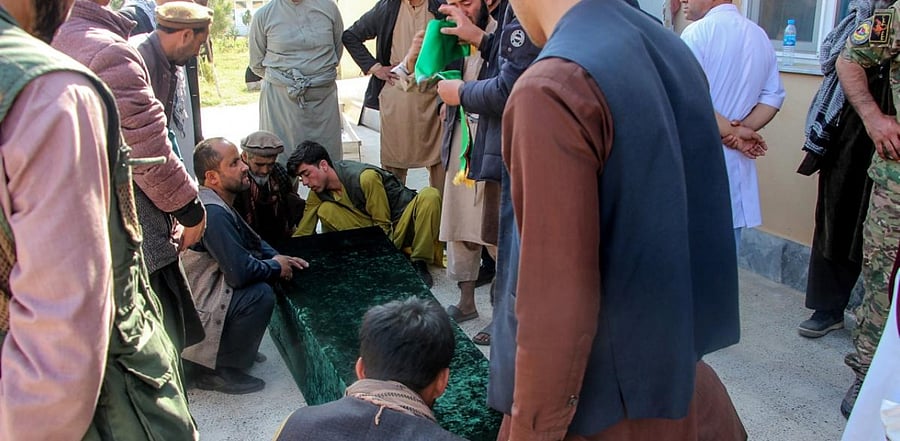 Relatives gather next to the coffin of a soldier outside a hospital after an ambush blamed on the Talibans killed at least 25 Afghan security force personnel as spiralling violence imperils ongoing peace talks, in Takhar province. Credit: AFP
