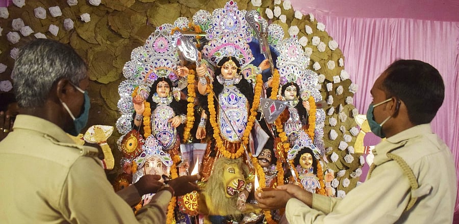 Devotees perform 'Aarti' at a community pandal during the ongoing Durga Puja festival. Credit: PTI