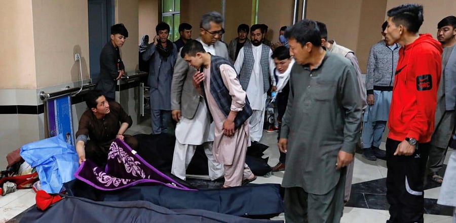 Afghan men look for their relatives at a hospital after a suicide bombing in Kabul, Afghanistan October 24. (Reuters)