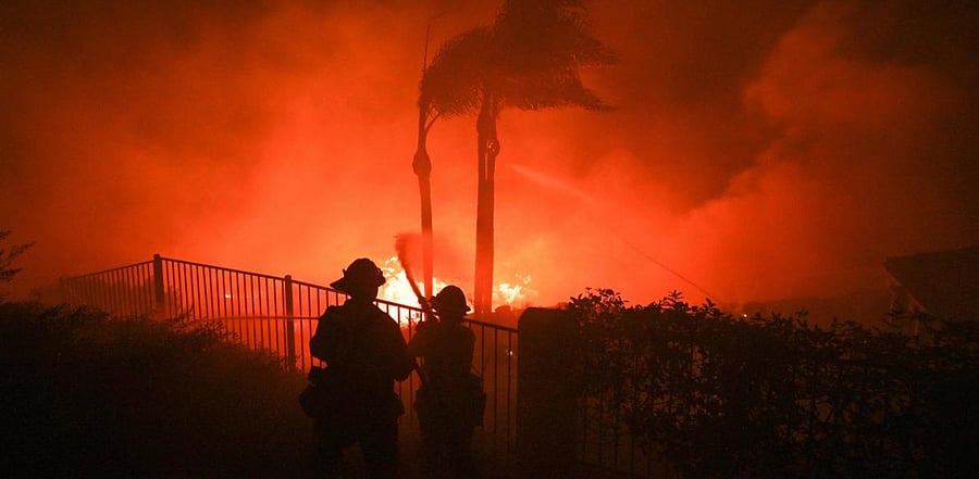 Firefighters try to surpress flames from a home patio at the Blue Ridge Fire in Yorba Linda, California, US. Credit: AFP Photo