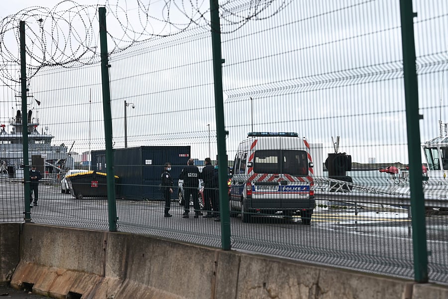 Police officers stand near a police car at Dunkerque port, northern France. Credit: AFP Photo