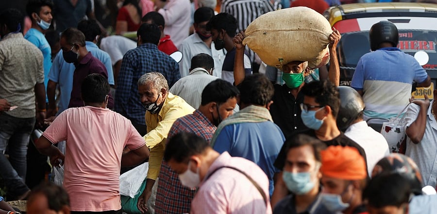 People are seen at a crowded market amidst the spread of the coronavirus disease in Mumbai. Credit: Reuters Photo