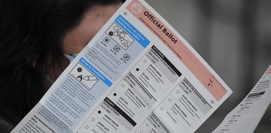 In this file photo taken on October 28, 2020 election workers extract mail-in ballots from their envelopes and examine the ballot for irregularities at the Los Angeles County Registrar Recorders' mail-in ballot processing center at the Pomona Fairplex in Pomona, California. Credit: AFP.