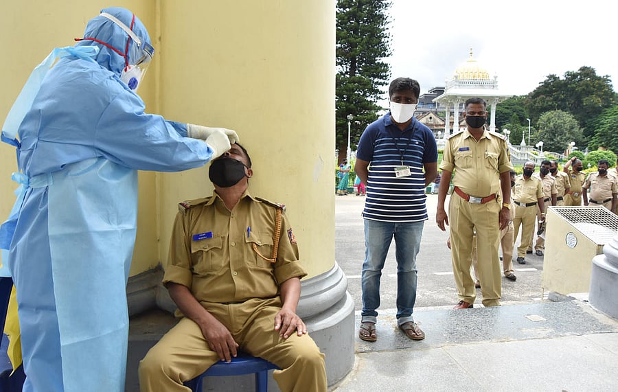 A police man undergoes Covid-19 test in Mysuru recently. Dh file photo