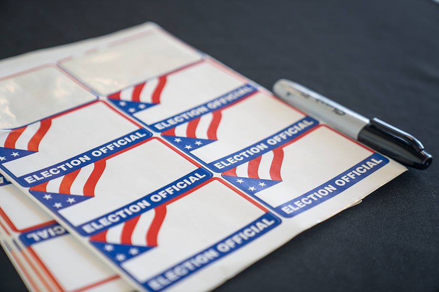 Name tags sit at the entrance of the sorting room where election workers process absentee ballots at State Farm Arena. Credits: AFP Photo