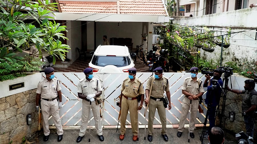 Security personnel stand guard outside the residence of Bineesh Kodiyeri, son of Kerala CPI(M) secretary Kodiyeri Balakrishnan. Credits: PTI Photo