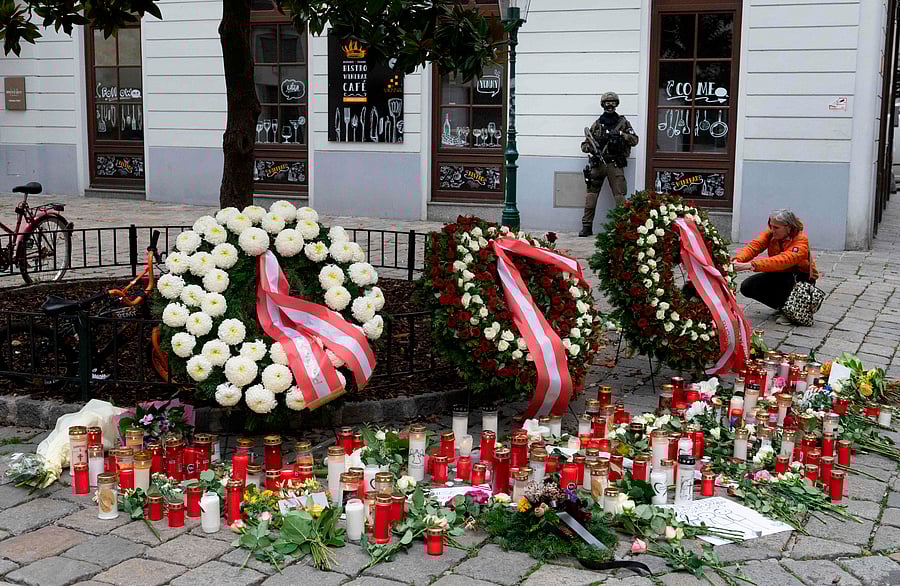 A women lights up a candle to commemorate the victims of a terrorist attack, in Vienna, Austria, on November 4, 2020. - Investigators are trying to piece together more information about the circle of the gunman after detaining 14 people in the wake of the shooting from November 2, 2020, the first major attack in Austria for decades and the first blamed on a jihadist. The assailant, named as 20-year-old dual Austrian-Macedonian national Kujtim Fejzulai, killed four people and left more wounded. Credit: AFP