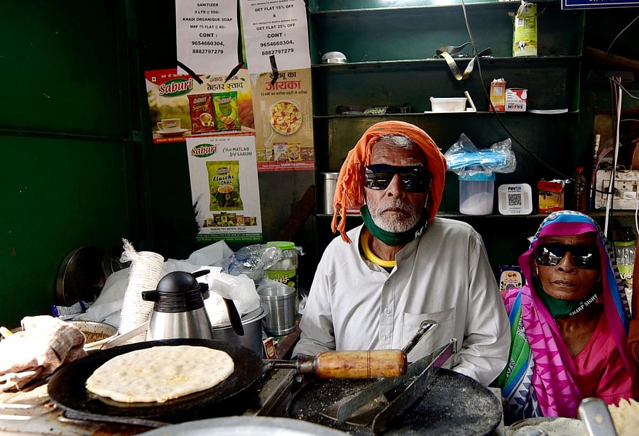 80-year-old Kanta Prasad and Badami Devi serve food at 'Baba Ka Dhaba', nearly a month after its owners' plight became viral on social media and revived their livlihood amid coronavirus pandemic. Credit: PTI