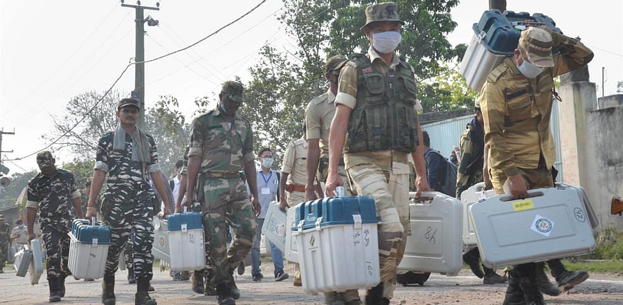 Security personnel carry Electronic Voting Machines (EVMs) as they leave for their election duty, ahead of the third and last leg of Bihar Assembly polls, in Muzaffarpur district. Credit: PTI Photo