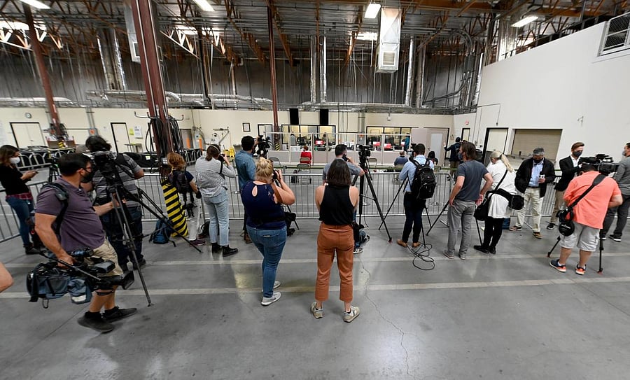 Members of the media look on as Clark County election workers count ballots at the Clark County Election Department. Credits: AFP Photo