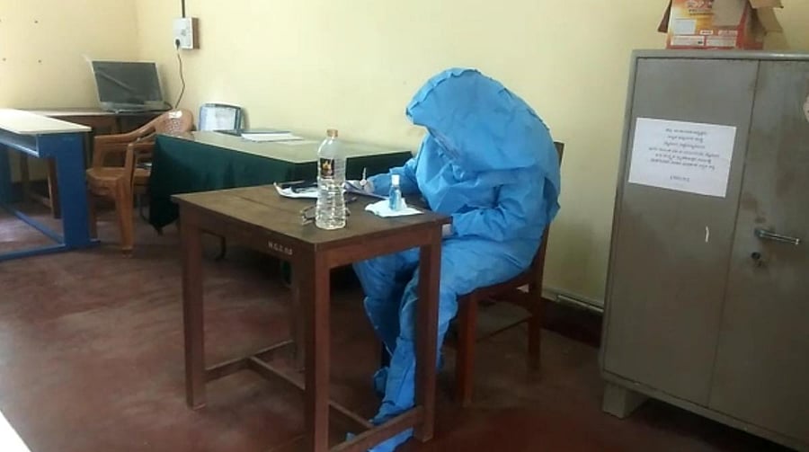 The Covid-19 infected student writes PG-CET in Mysuru on Saturday. DH PHOTO