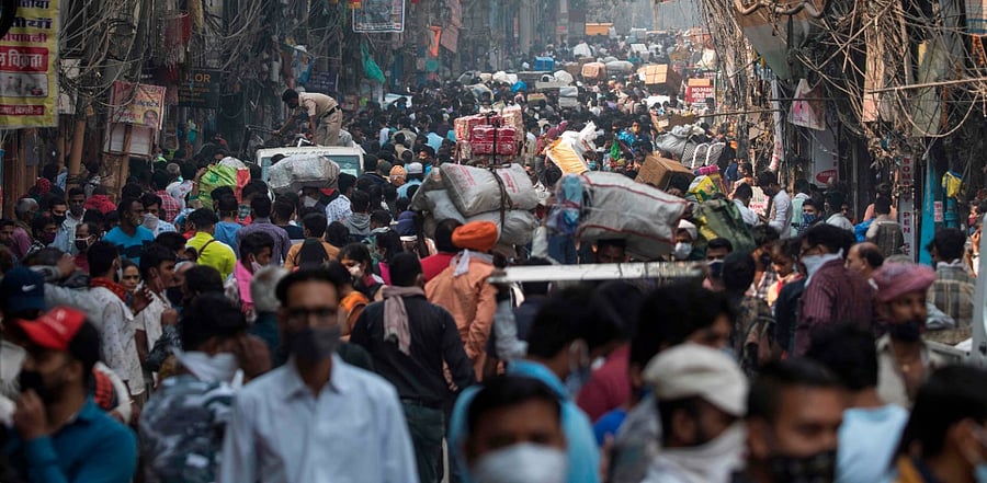 People walk along a street of a market area amid the Covid-19 pandemic. credit: AFP Photo