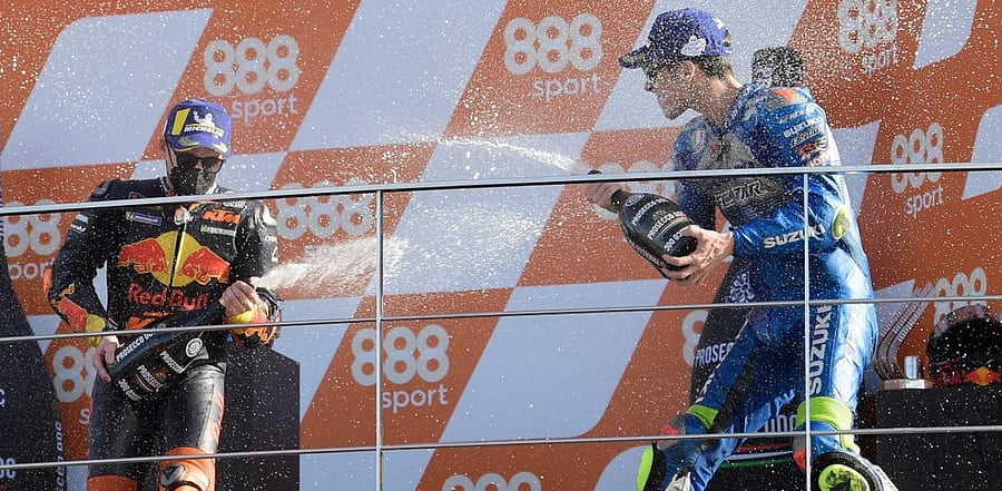 Race winner Suzuki Ecstar's Spanish rider Joan Mir (R) celebrates on the podium with third placed Red Bull KTM Factory Racing's Spanish rider Pol Espargaro after the MotoGP race of the European Grand Prix at the Ricardo Tormo circuit in Valencia. Credit: AFP Photo