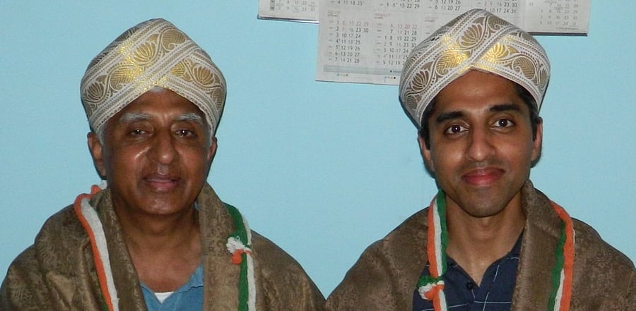 Dr Vivek Murthy, along with his father Dr H N Lakshminarasimha Murthy, during one of his visit to his native Hallegere, in Mandya district. (DH Photo)