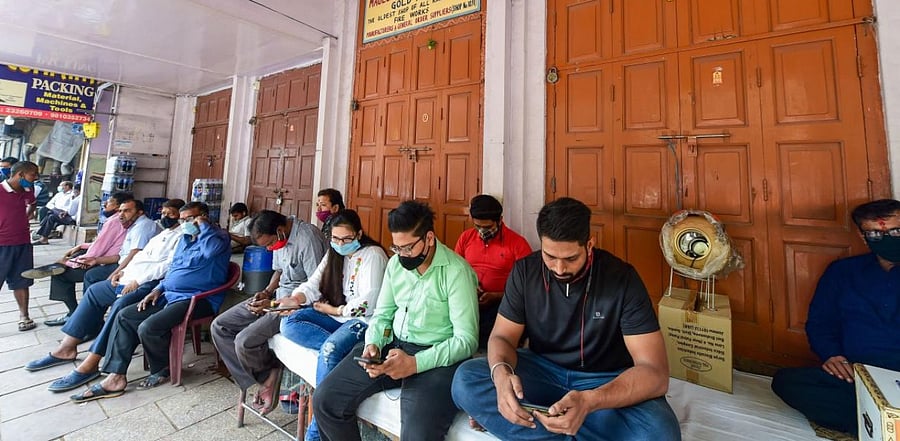 Salespersons sit outside the closed firecrackers' shops after the Delhi government put a ban on bursting and sale of all kinds of firecrackers from November 7 to November 30, owing to rising air pollution, ahead of the Diwali festival, in Old Delhi. Credit: PTI.